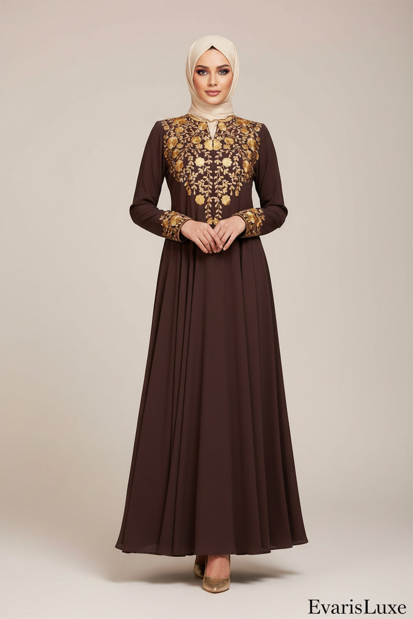 Woman wearing a long brown dress with gold embroidery in an outdoor setting.