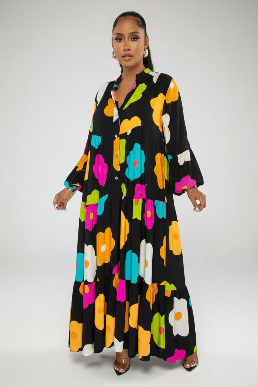 Woman wearing a black dress with colorful floral pattern on a white background