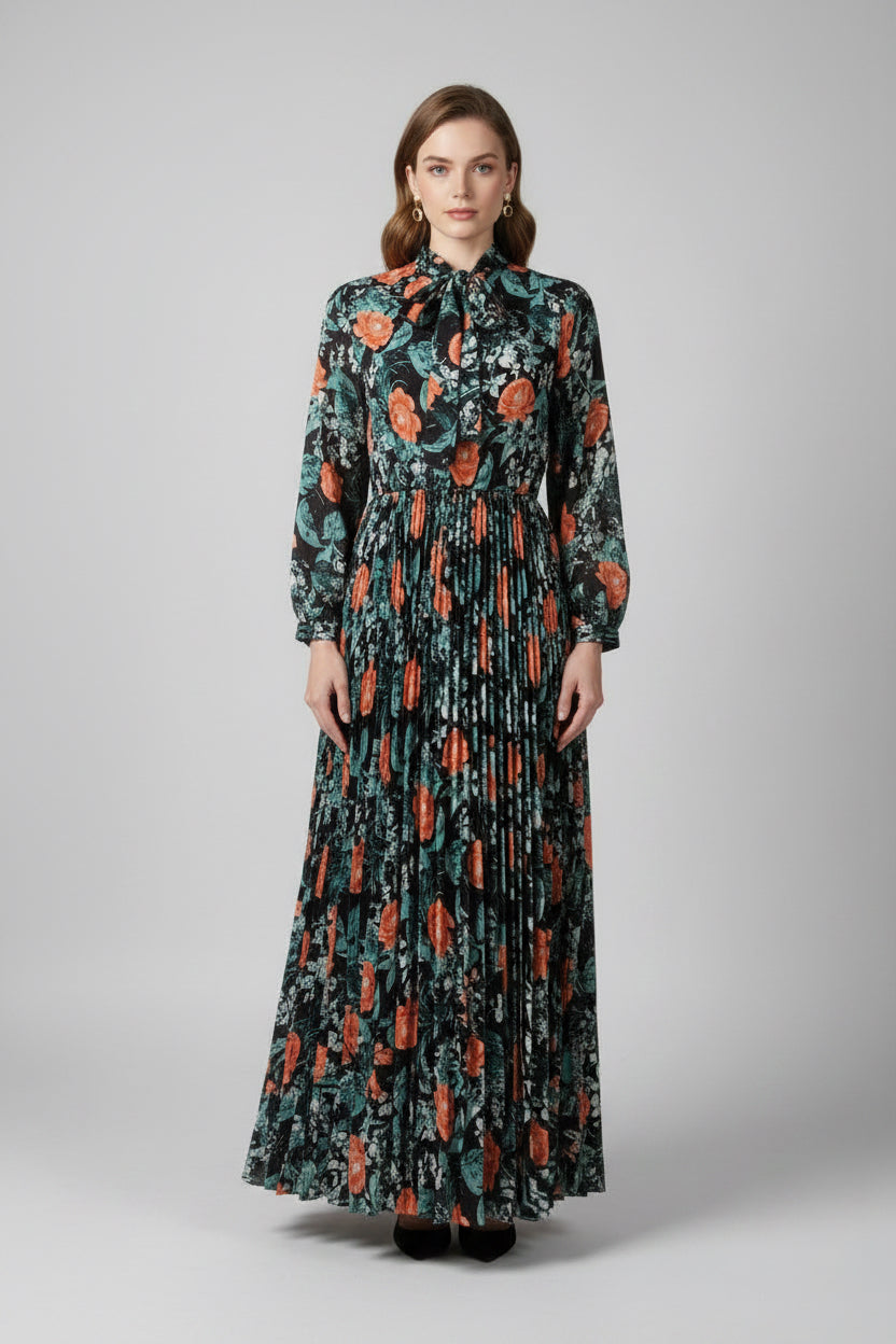 Woman wearing a floral dress with long sleeves and orange flowers, standing next to a close-up of the dress on a wooden surface.