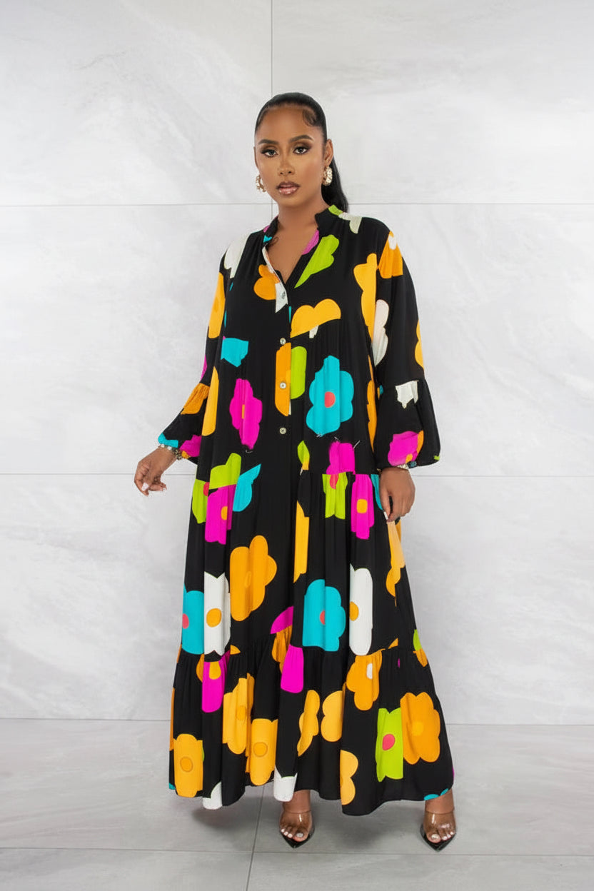 Woman wearing a black dress with colorful floral patterns against a white background