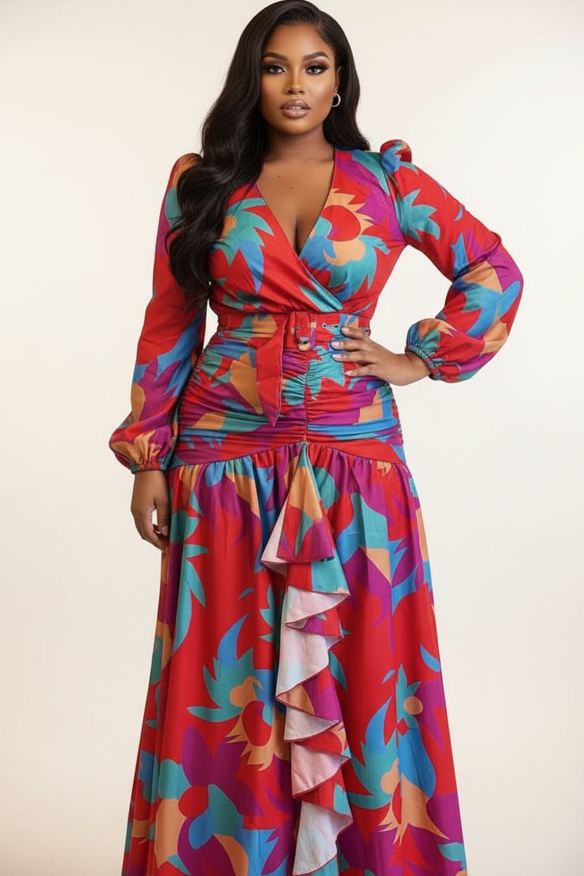 Person wearing a colorful floral dress standing in front of leopard print curtains.