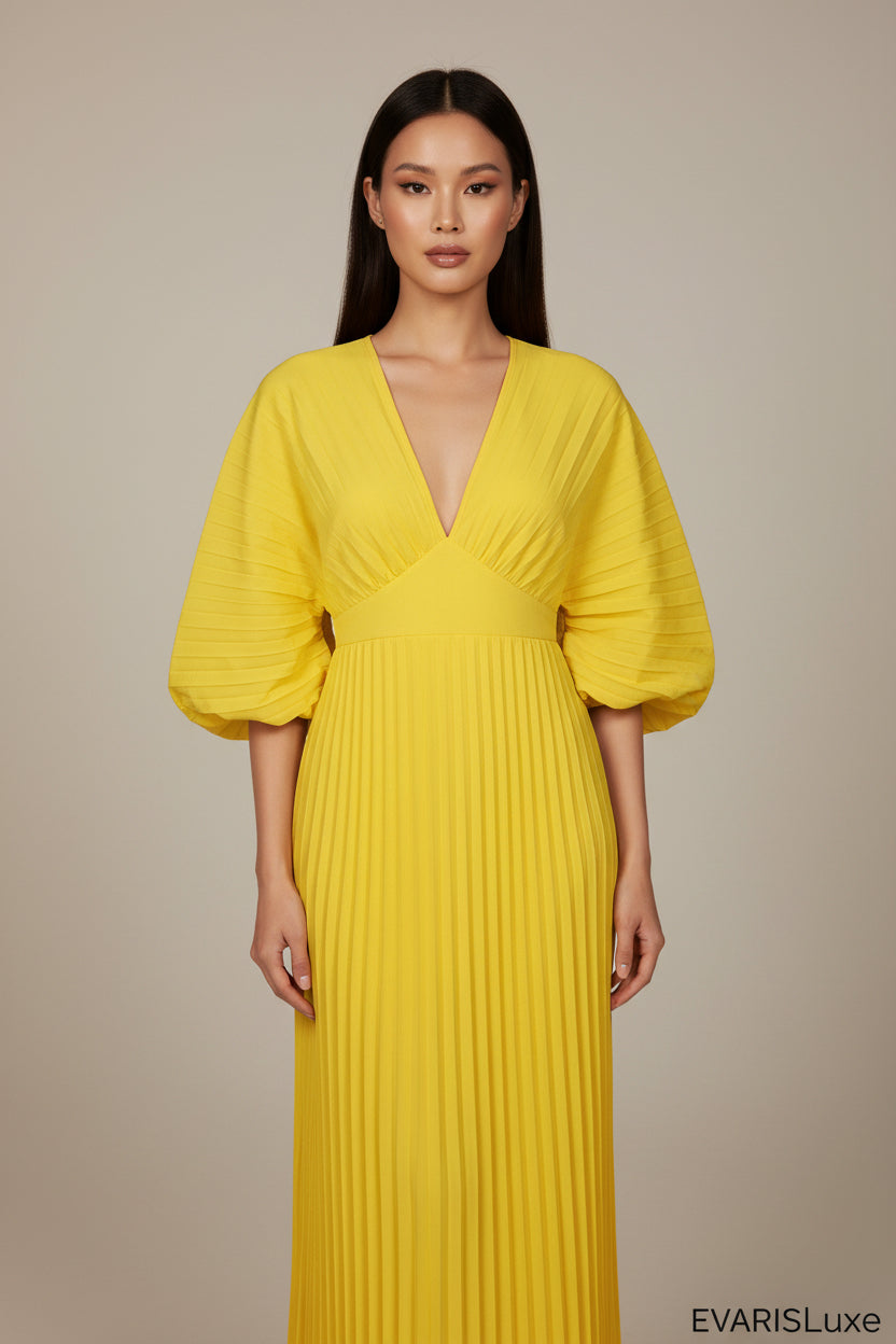 Yellow pleated dress on a white background