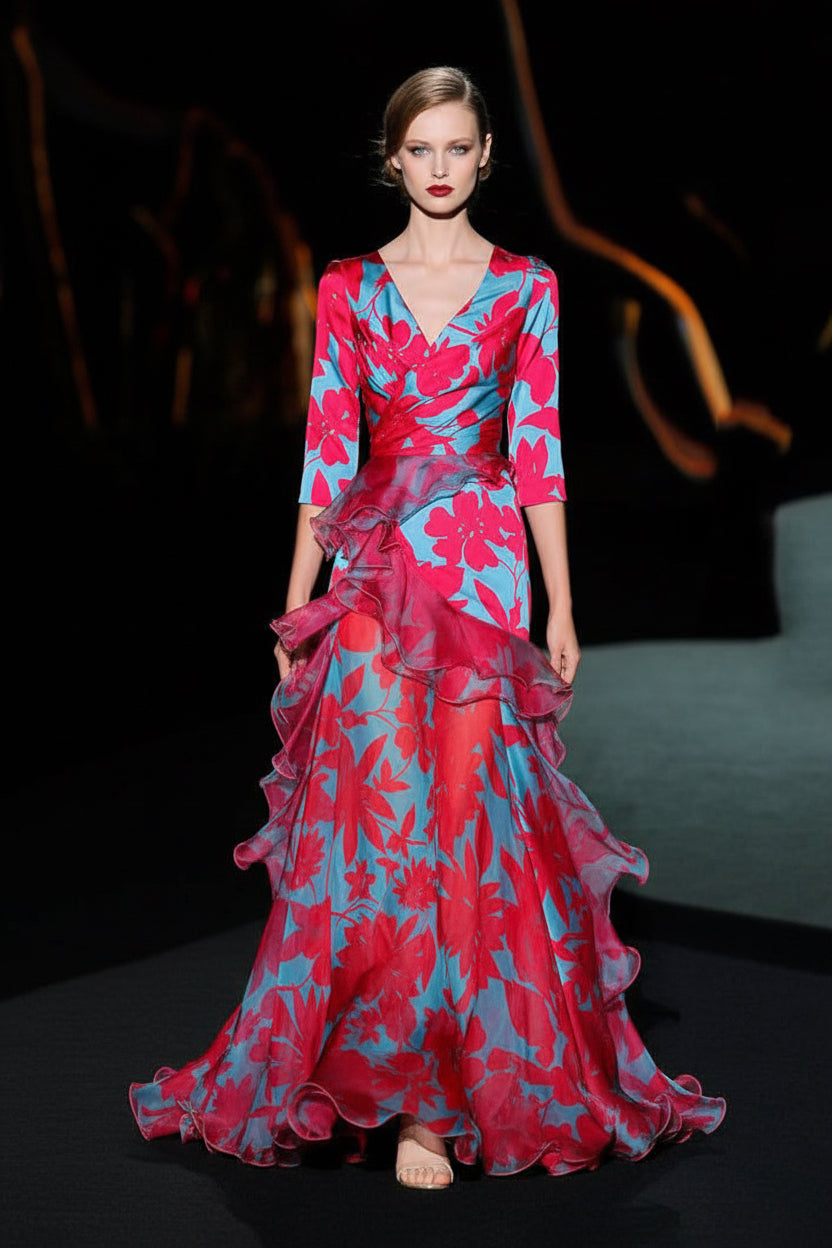 Woman wearing a vibrant floral dress on a dark background