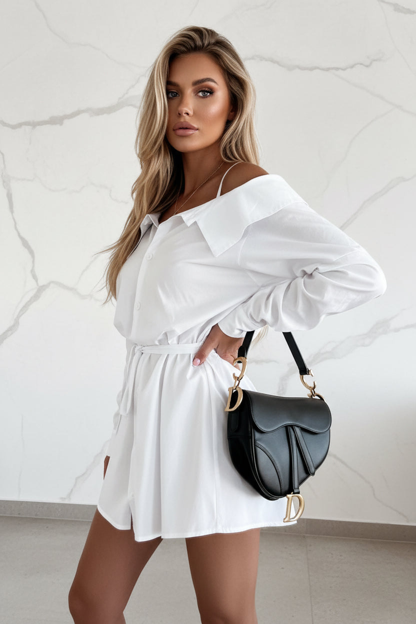 White off-shoulder dress worn by a person indoors.