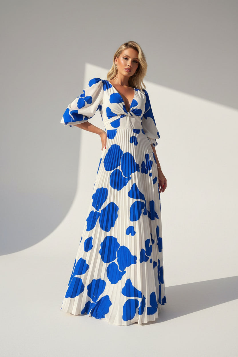 Woman wearing a white dress with blue floral patterns on a white background