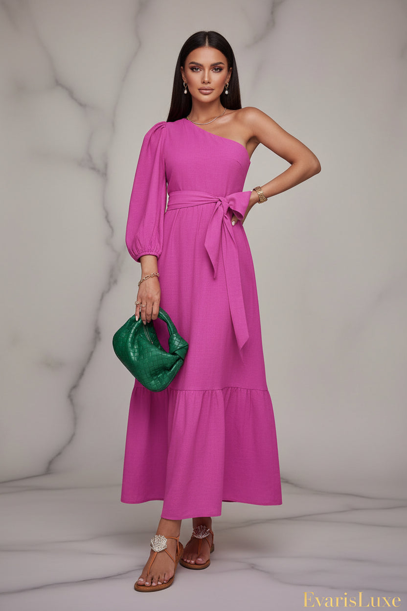 Woman in a pink dress holding a green clutch in front of tropical plants
