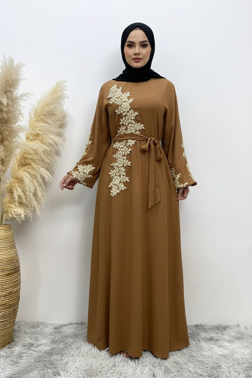 Brown dress with floral embroidery on a white background