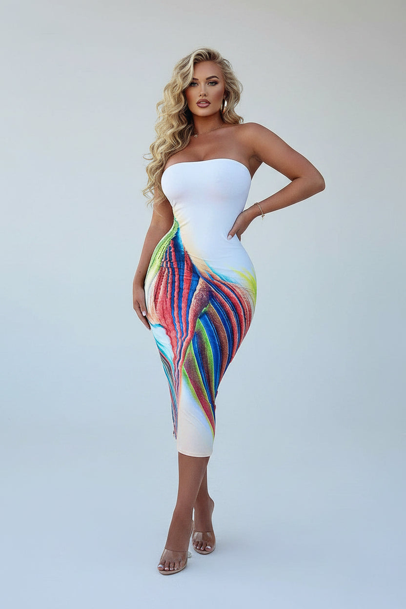 Woman wearing a strapless dress with a colorful bottom half on a white background