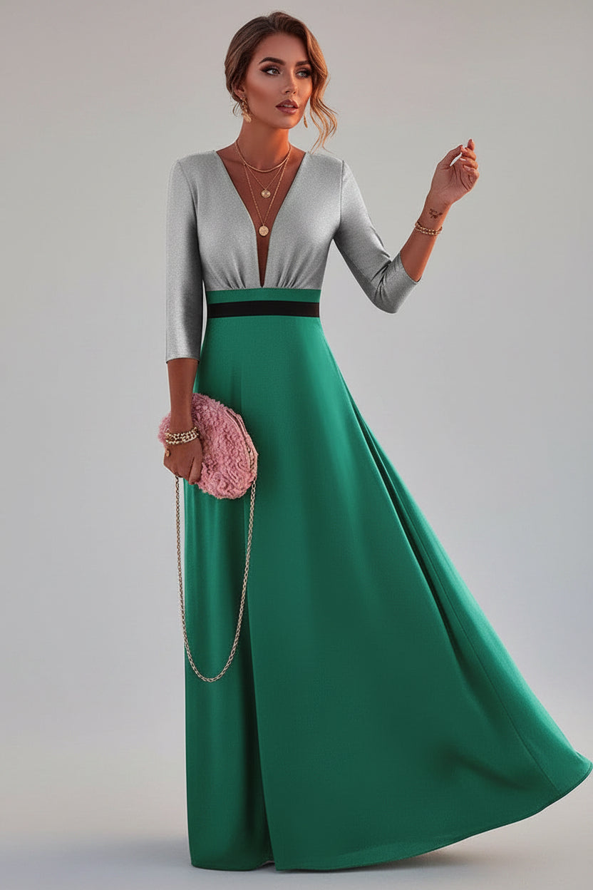 Woman in a green and gray dress with a pink clutch against a scenic background.
