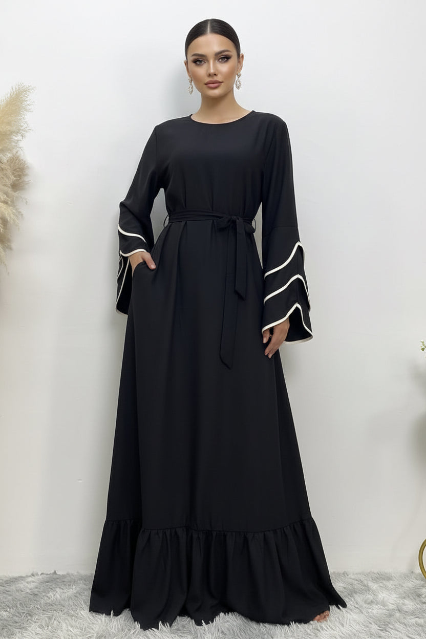 Black dress with white trim on a white background