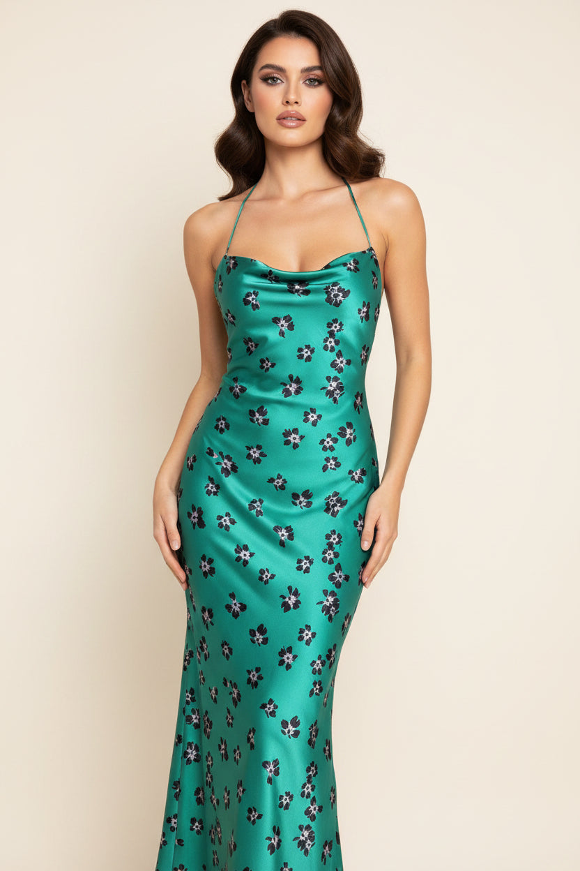 Teal dress with floral pattern on a mannequin against a white background