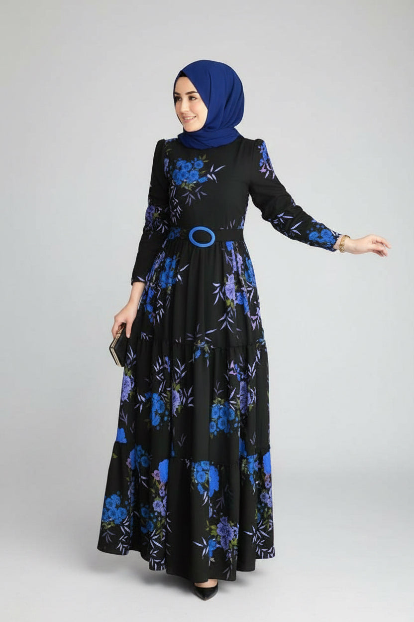 Woman wearing a black dress with blue floral patterns on a white background