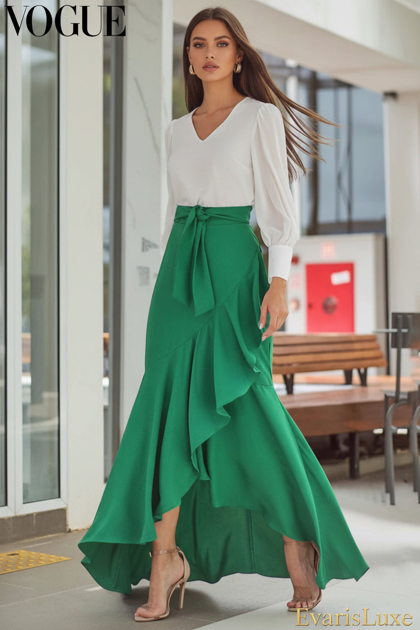 Person wearing a green dress with ruffled layers in an outdoor setting.