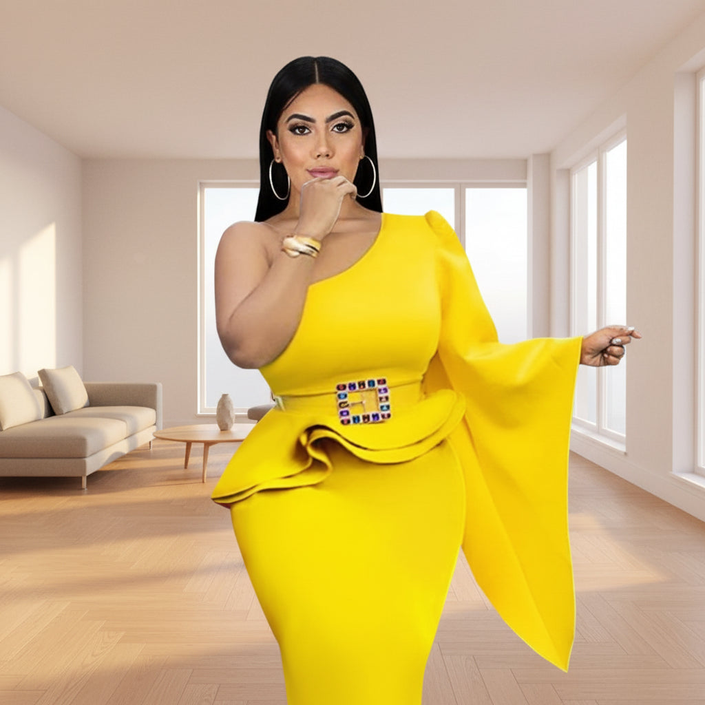 Woman in a yellow one-shoulder dress with a decorative belt in an elegant room.