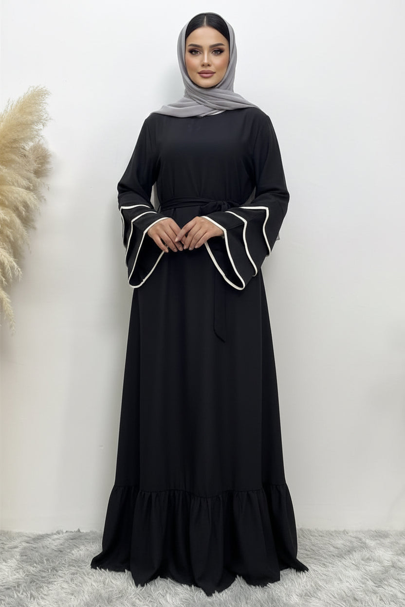 Black dress with white trim on a white background
