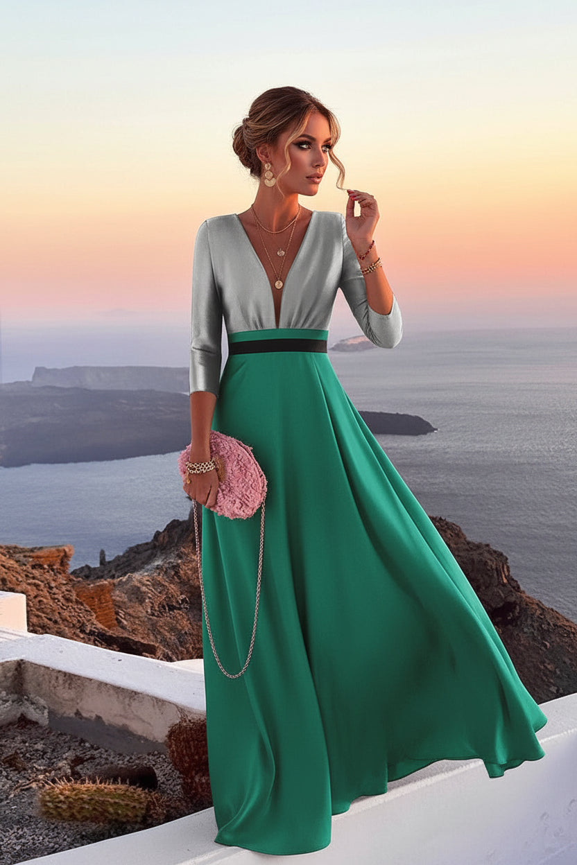 Woman in a green and gray dress with a pink clutch against a scenic background.