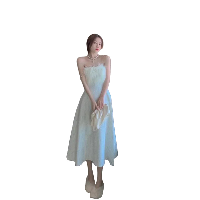 Woman in a white dress standing in a modern living room.