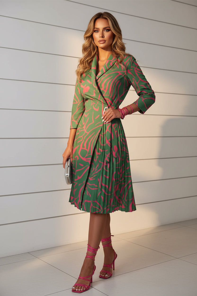 Green and pink patterned dress worn by a person indoors.