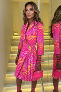 Person wearing a pink and yellow zebra print outfit with matching handbag.