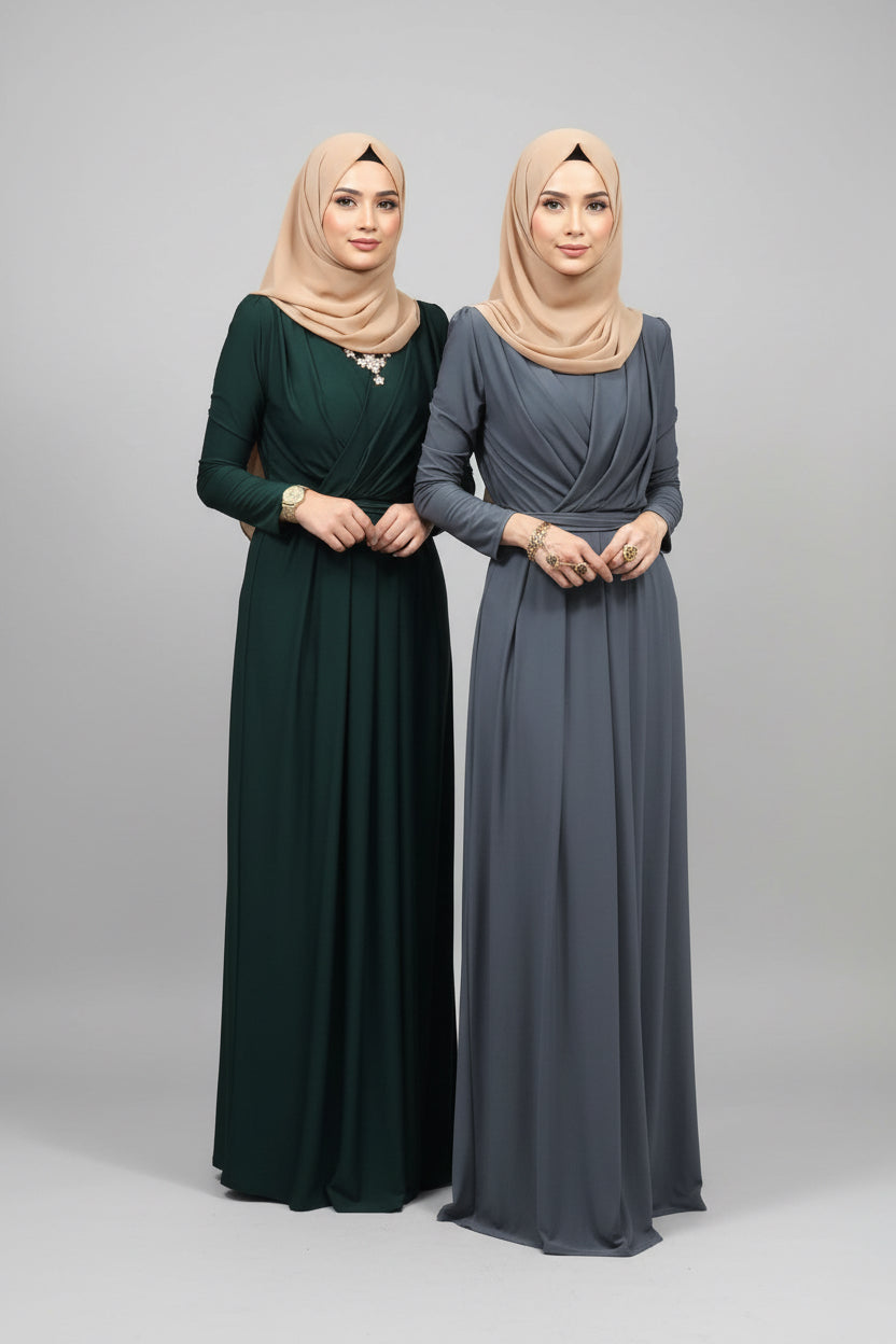 Two women wearing long dresses in front of a mirror.