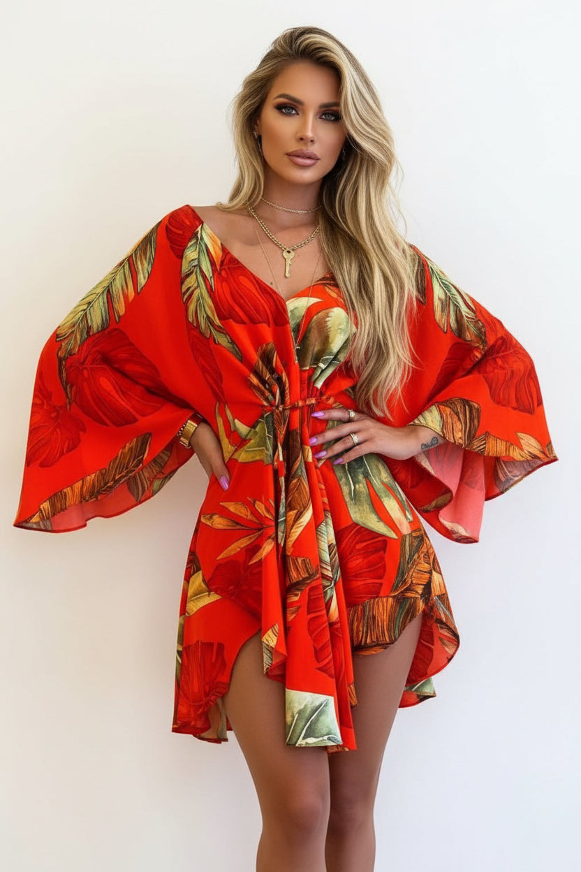 Red dress with tropical leaf pattern worn by a person on a beige background