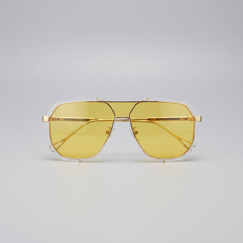 Yellow sunglasses held by a hand with a blurred background