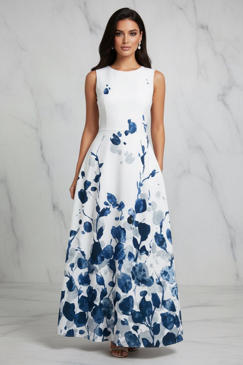 Woman wearing a white dress with blue floral pattern on a gray background