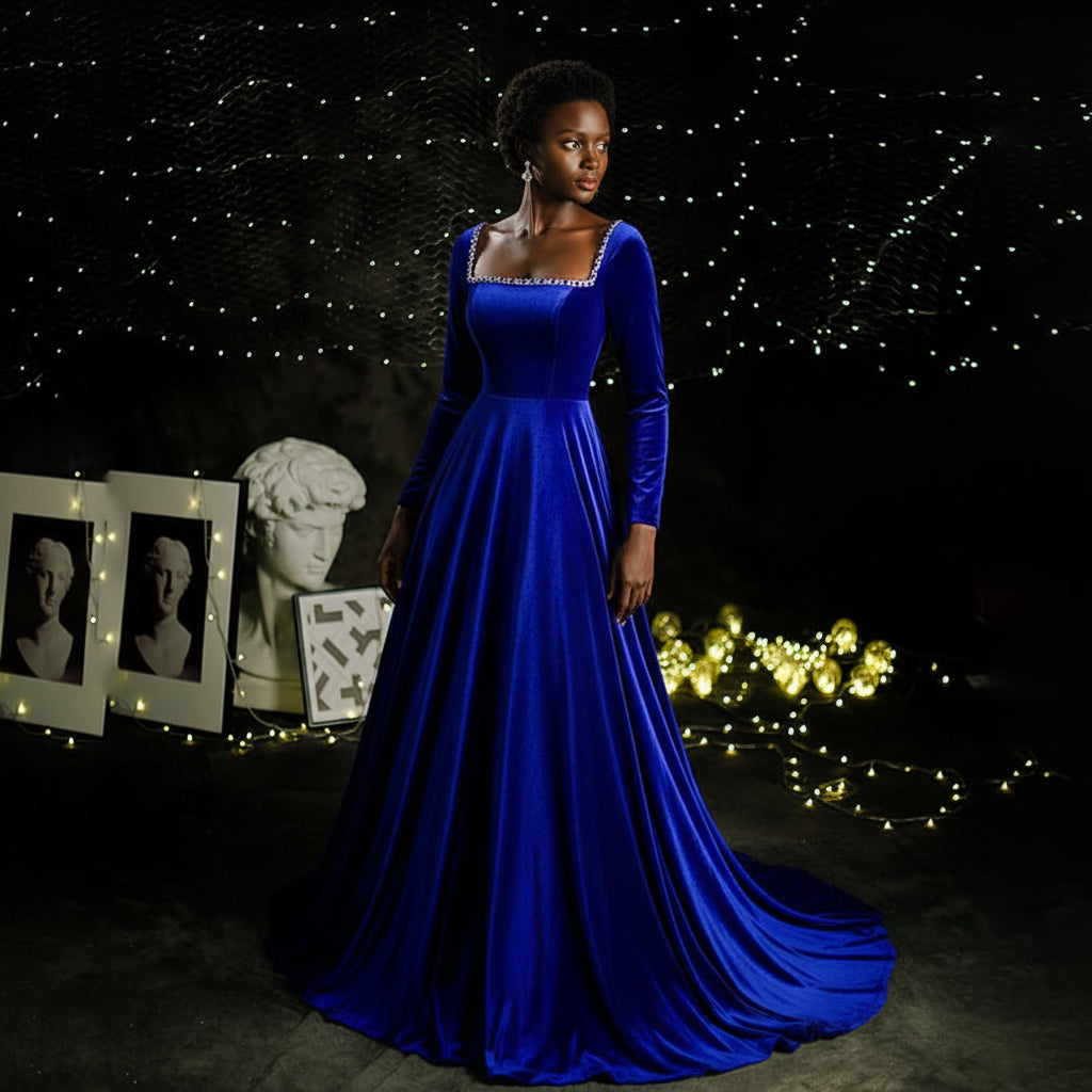 Blue evening gown on a mannequin against a dark background with decorative elements.