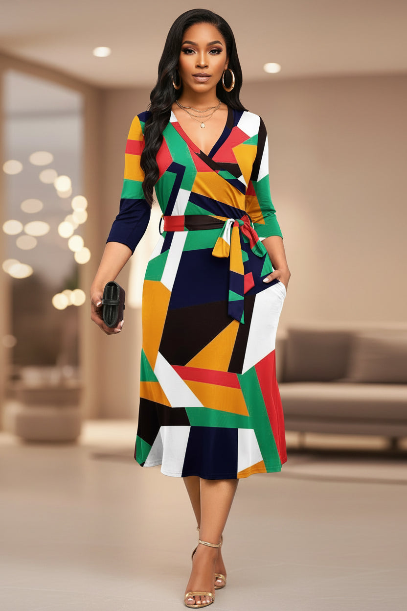 Colorful geometric patterned dress worn by a model on a white background