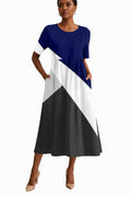 Color-blocked dress with blue, white, and black sections on a white background