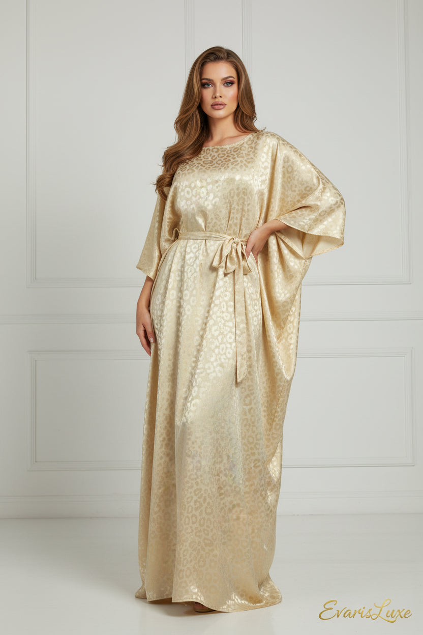 Gold patterned dress on a mannequin against a white background