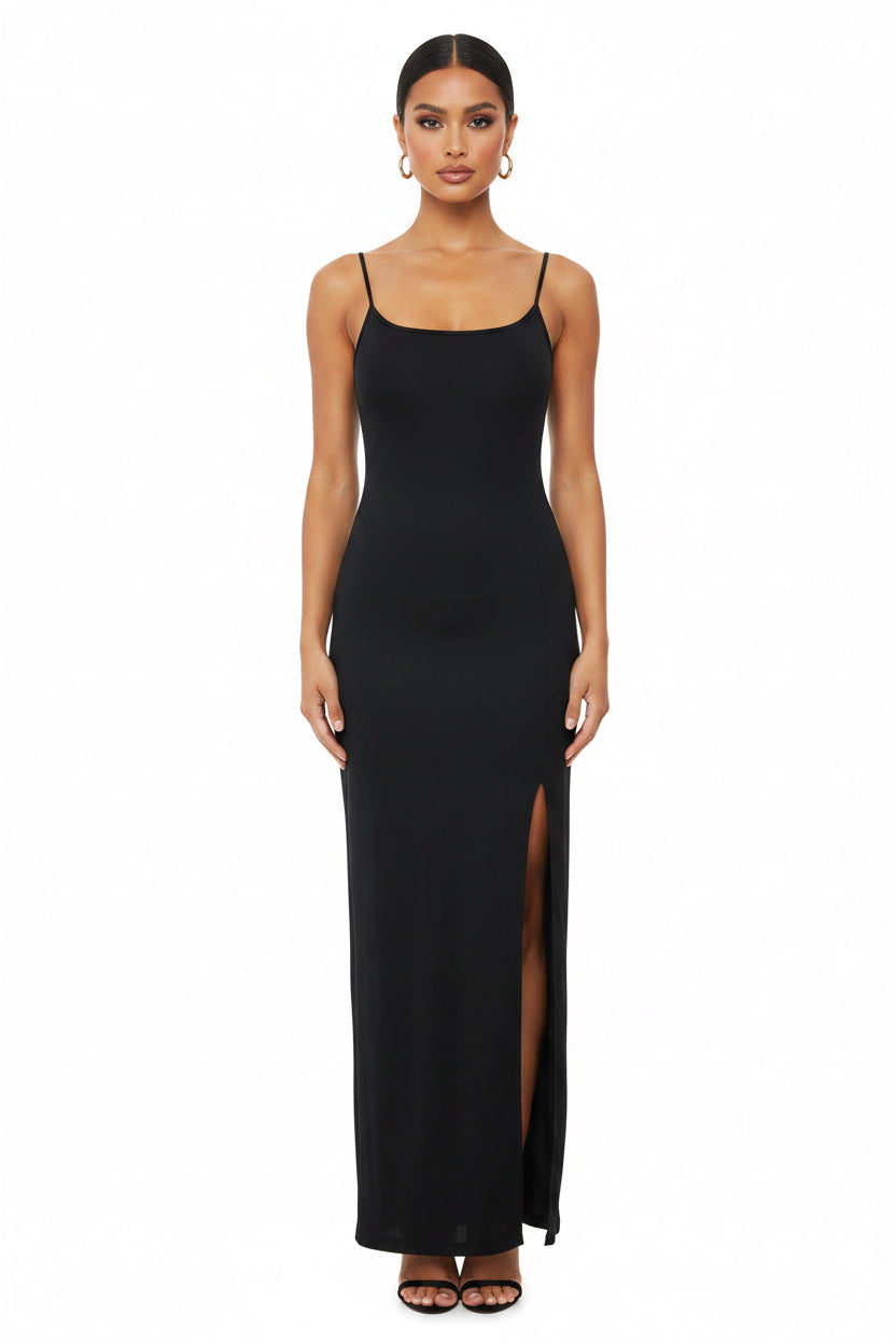 Black slip dress with a slit on a white background