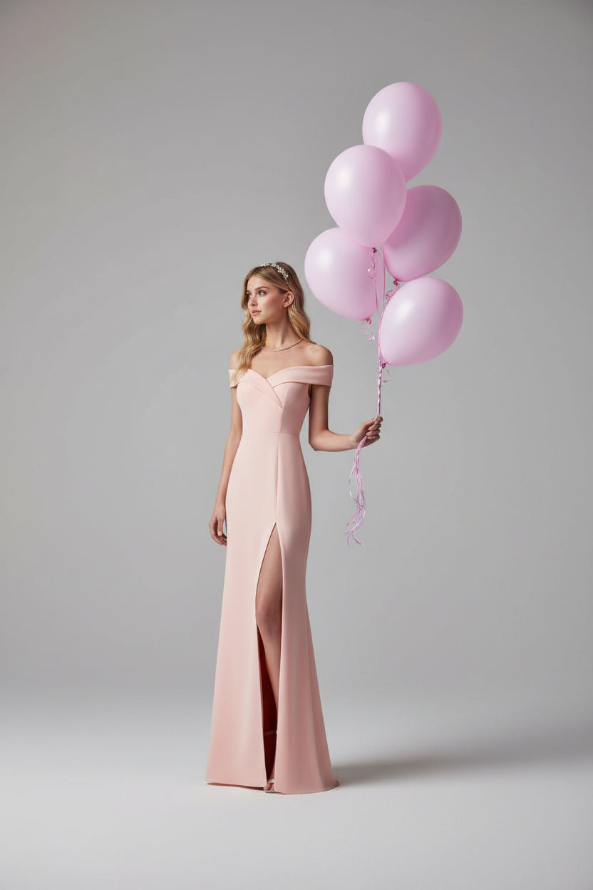Woman in a pink dress holding balloons on a boardwalk with ocean and cityscape in the background