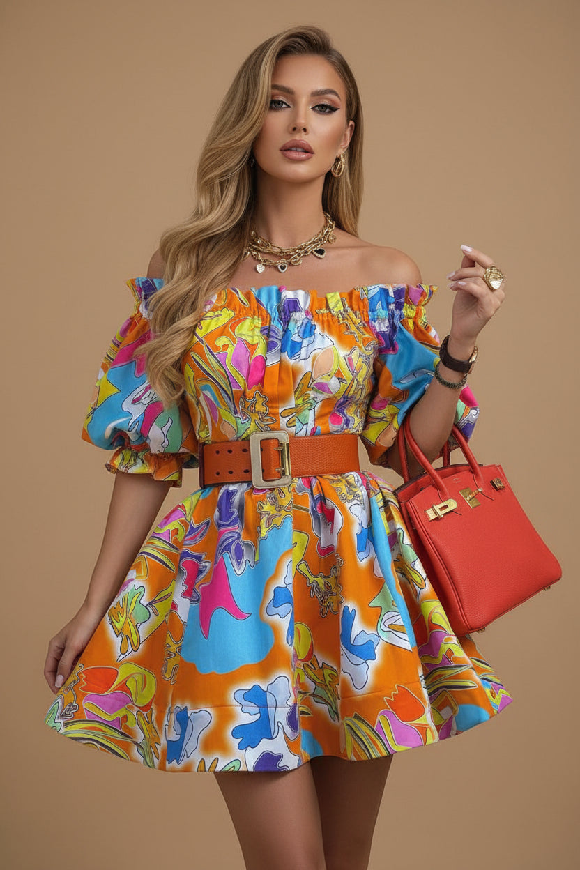 Woman wearing a colorful dress with a red handbag in an outdoor setting