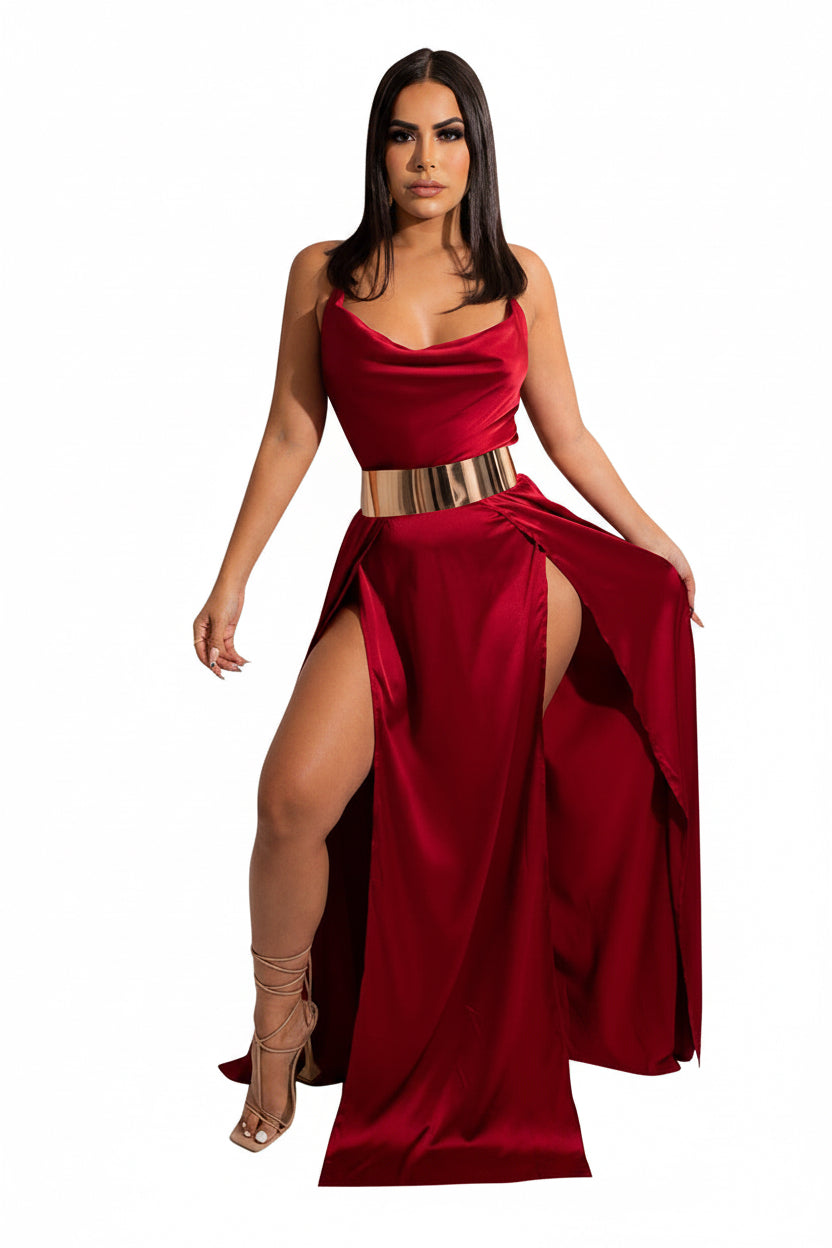 Woman wearing a red evening gown with a high slit on a white background