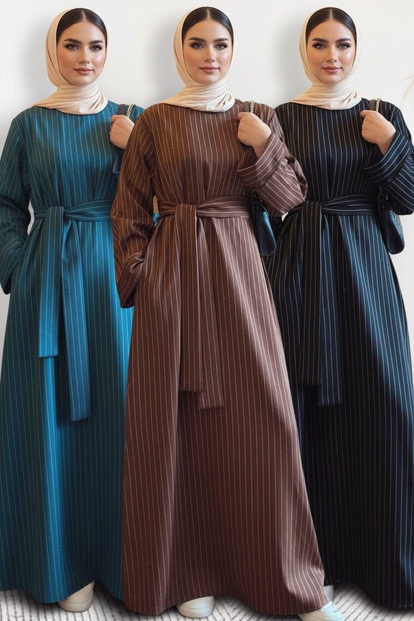 Three women wearing long, striped dresses in blue, brown, and black.