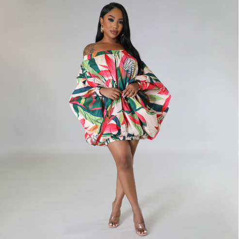 Woman wearing a colorful floral dress on a gray background