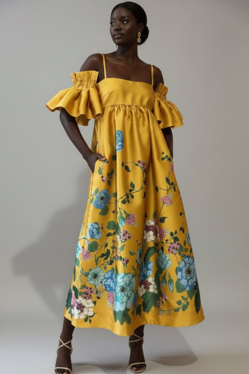 Woman wearing a yellow floral dress against a neutral background