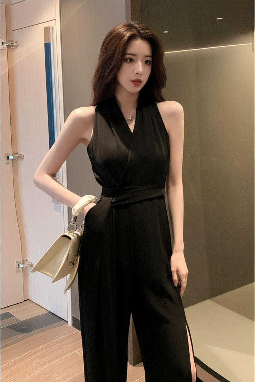 Woman in a black dress taking a mirror selfie in an indoor setting.