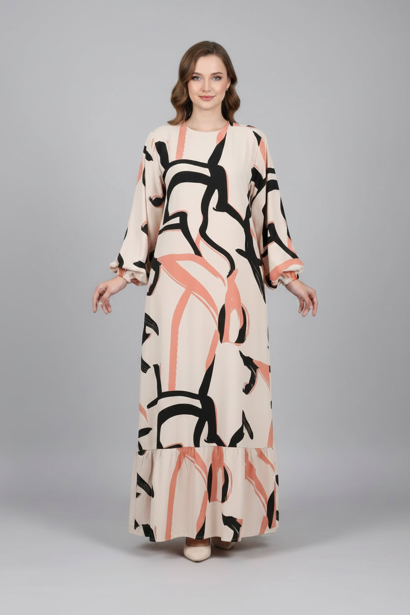 Person wearing a long dress with abstract pattern in a minimal indoor setting