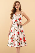 Floral dress on a hanger with a pink bag on a beige background