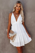 Woman wearing a white dress against a neutral background