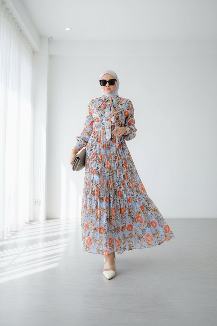 Woman wearing a floral dress with a close-up of the dress on a wooden floor.