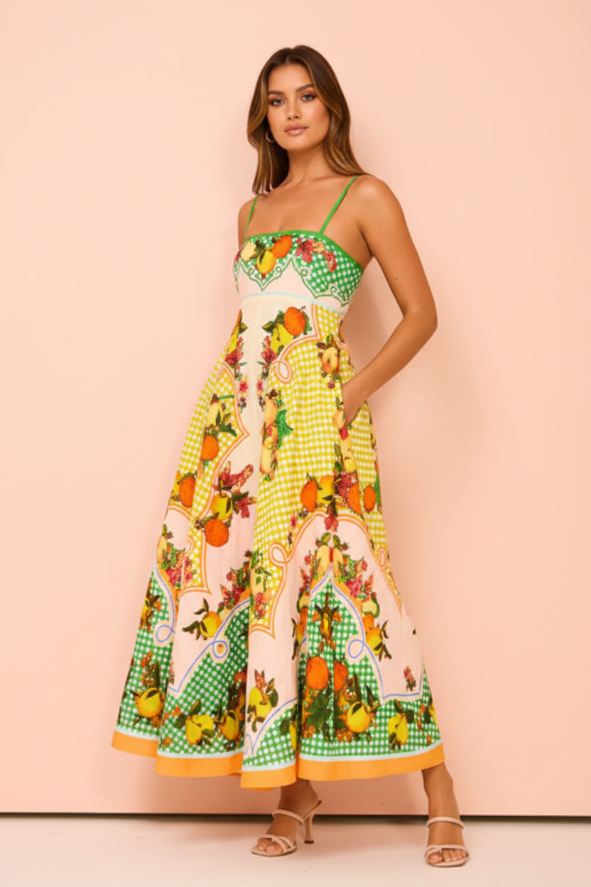 Woman wearing a colorful patterned dress with a pink background