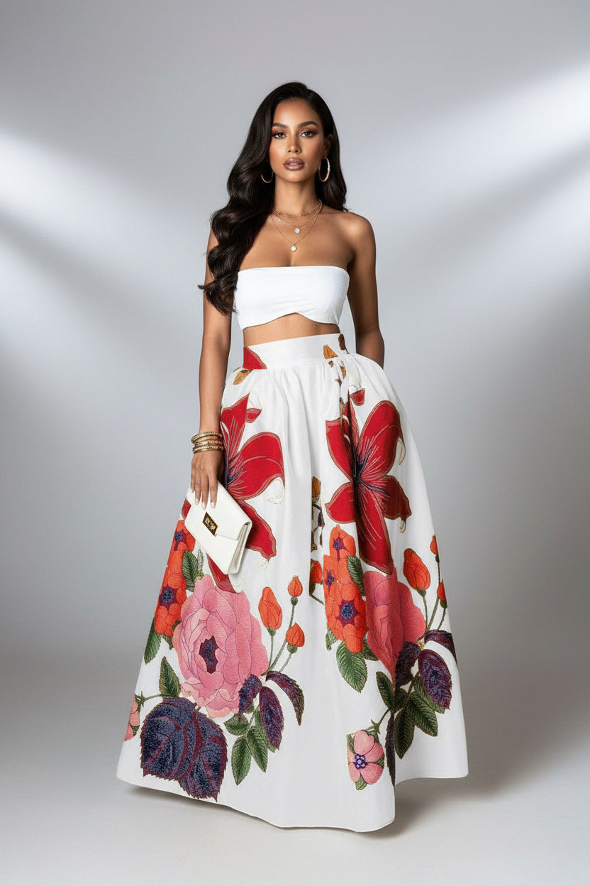 Woman wearing a white floral skirt with red and pink flowers on a plain background