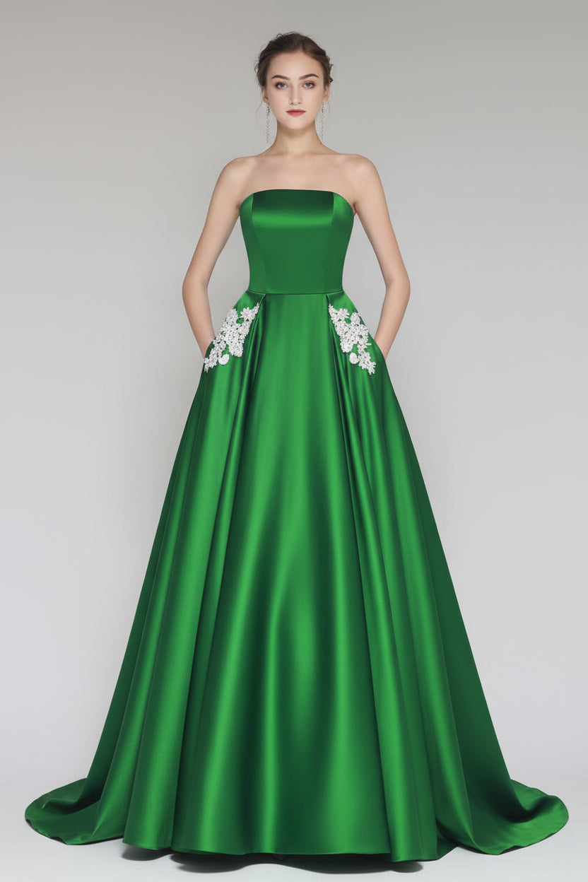 Green strapless gown with floral details on a gray background