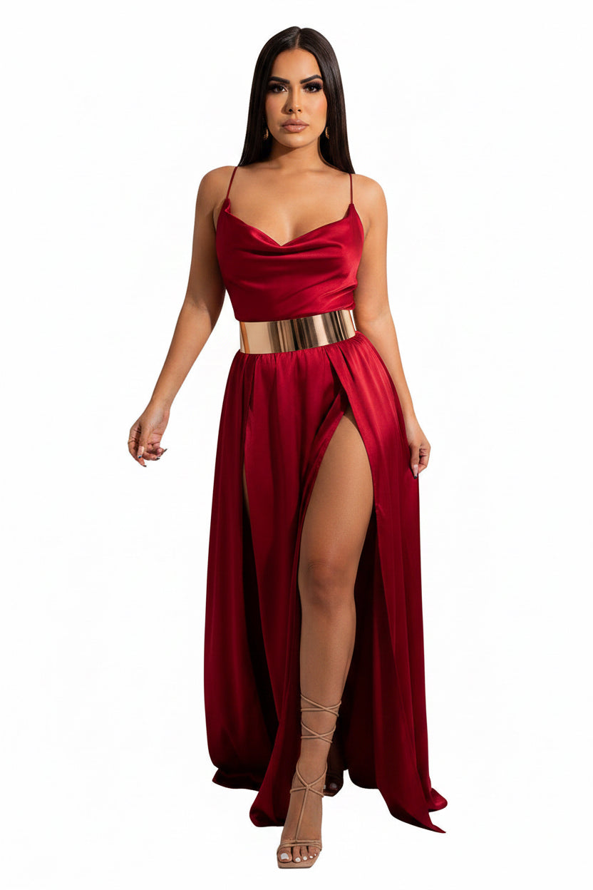 Woman wearing a red evening gown with a high slit on a white background