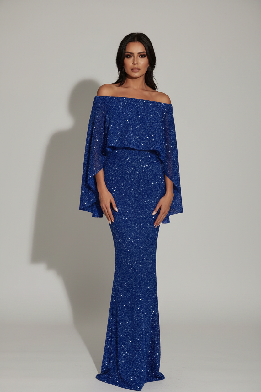 Woman wearing a blue off-shoulder dress in a decorative room.
