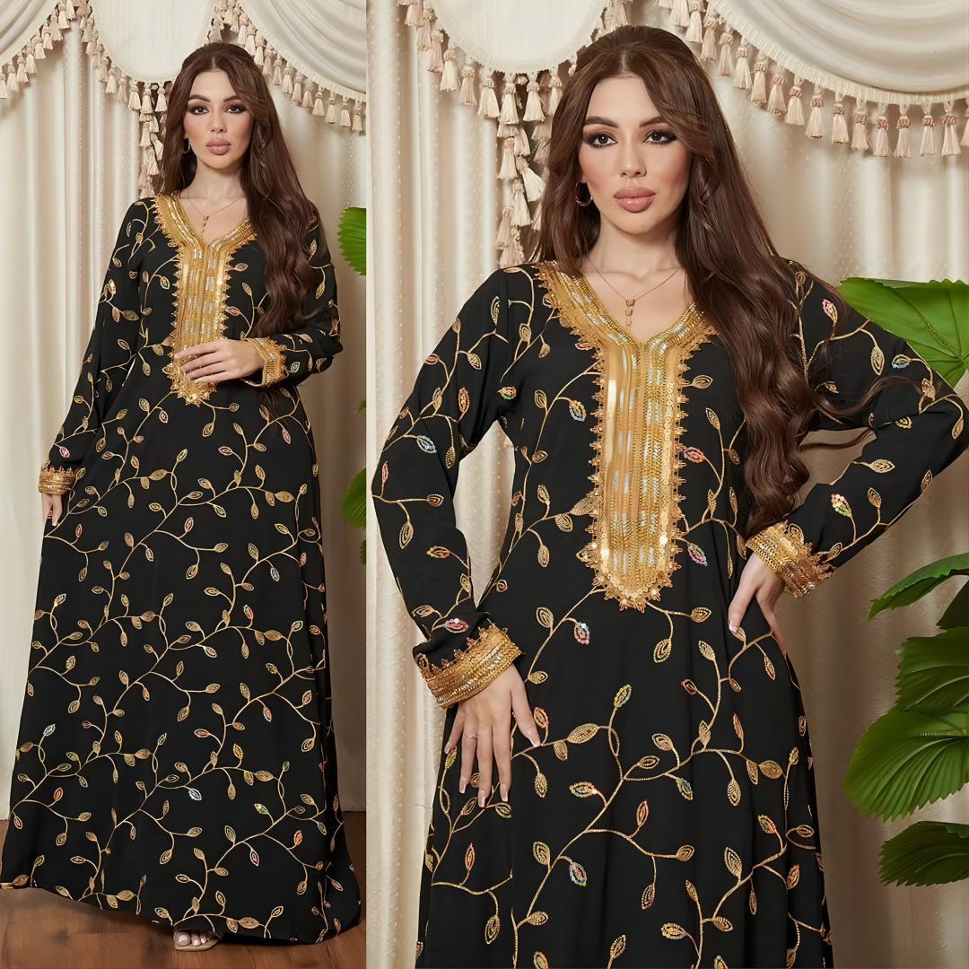 Woman wearing a black dress with gold embroidery in a decorated room.