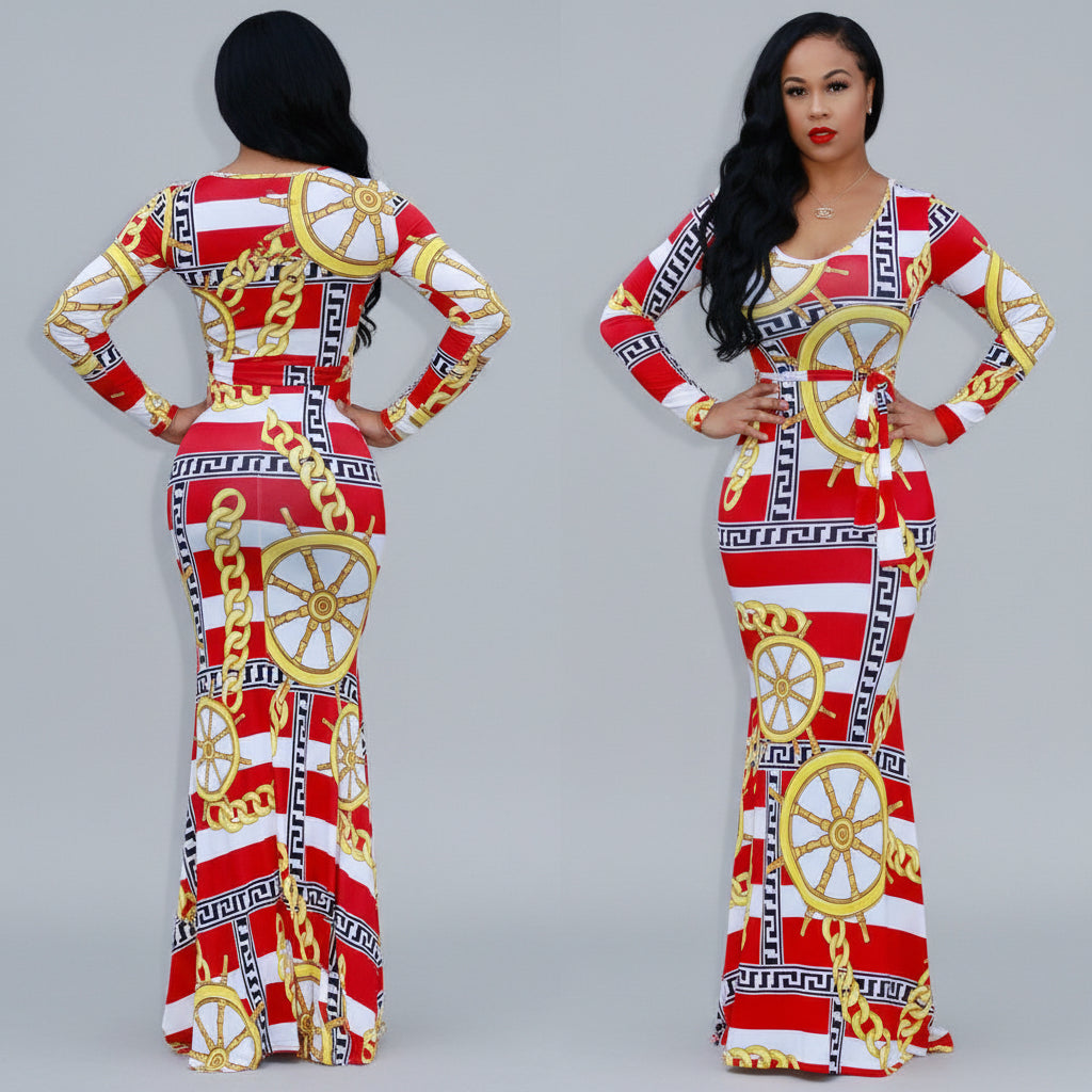 Woman wearing a red, white, and gold patterned dress with a reflective surface.